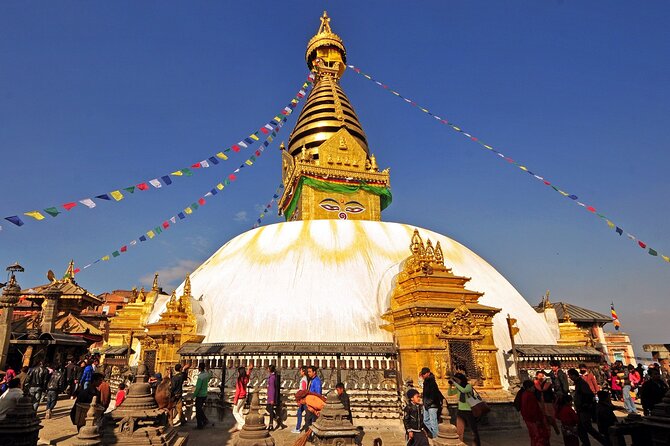 Prayer flags over the white dome and gold spire of Boudhanath stupa